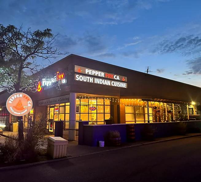 Pepperfry.ca restaurant building on Matheson Blvd E at dusk, with warm lights in the windows