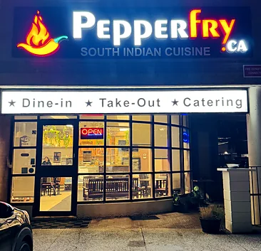 Pepperfry.ca South Indian Cuisine storefront at night, with the lit sign and Dine-in, Take-Out and Catering banner