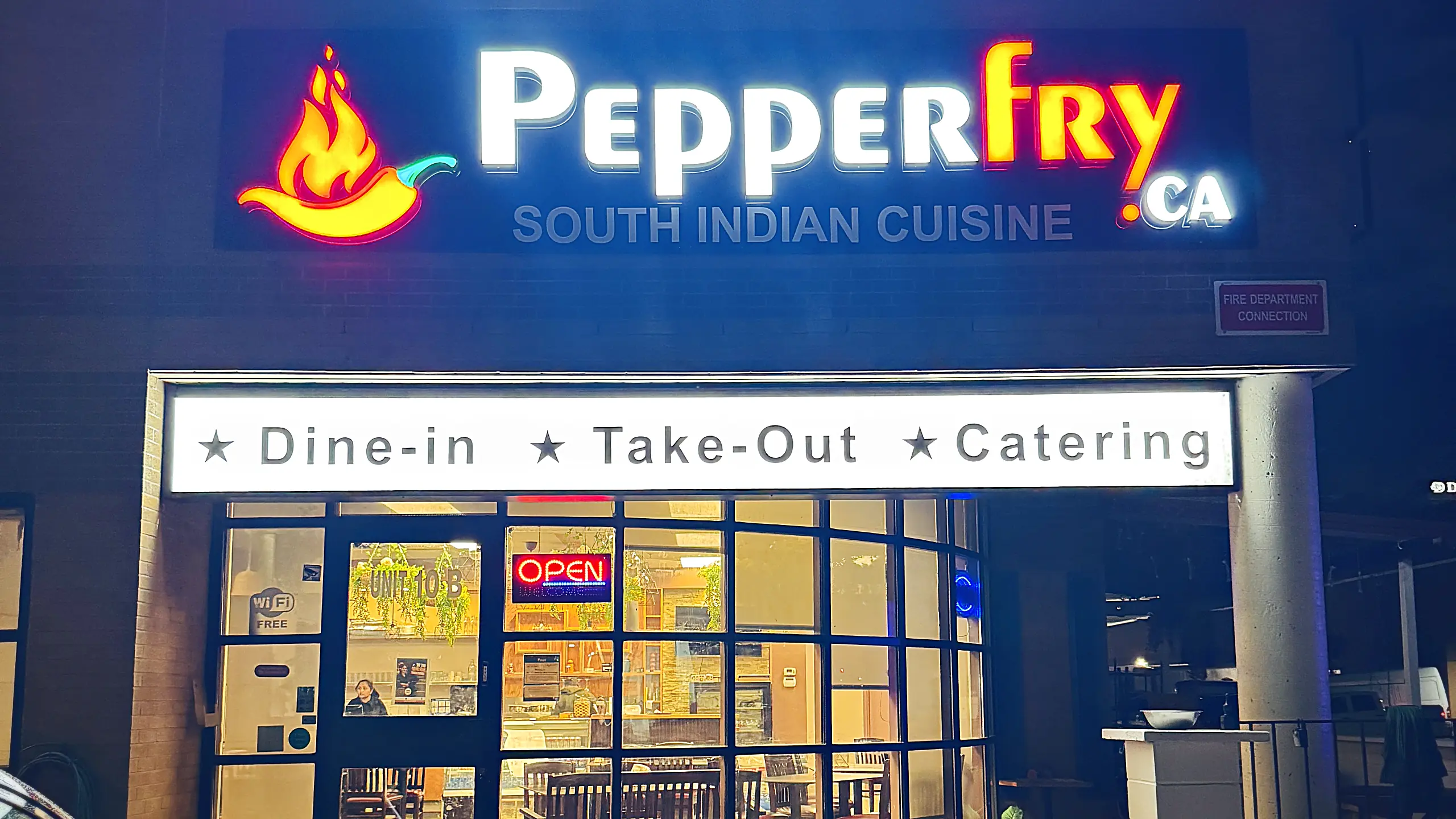 Pepperfry.ca South Indian Cuisine storefront at night, with the lit sign and Dine-in, Take-Out and Catering banner